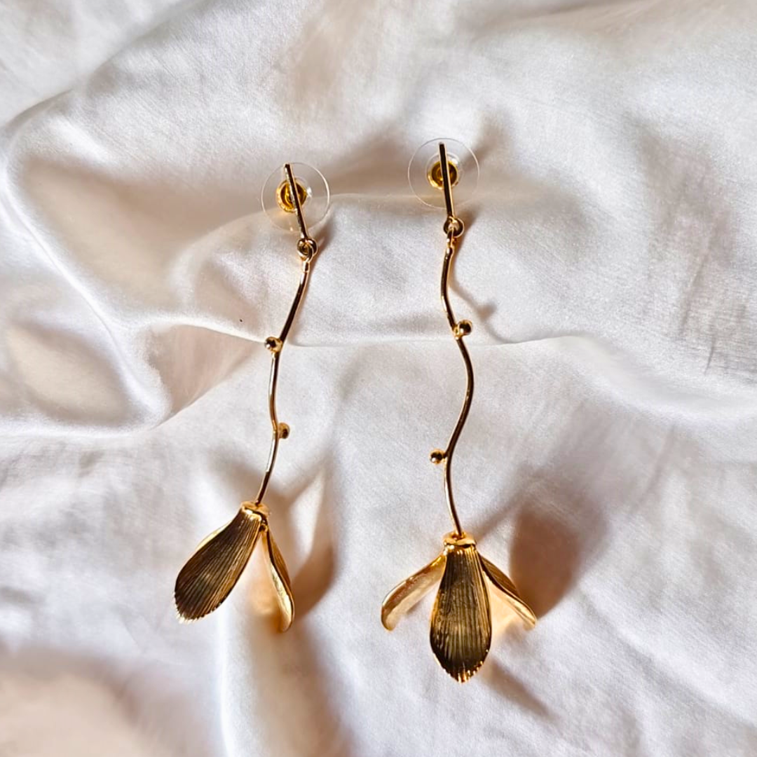 Hanging flower earrings with matte-gold petals and flowing vine stems, made from brass and 18K rhodium gold plating