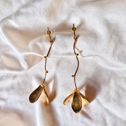 Hanging flower earrings with matte-gold petals and flowing vine stems, made from brass and 18K rhodium gold plating