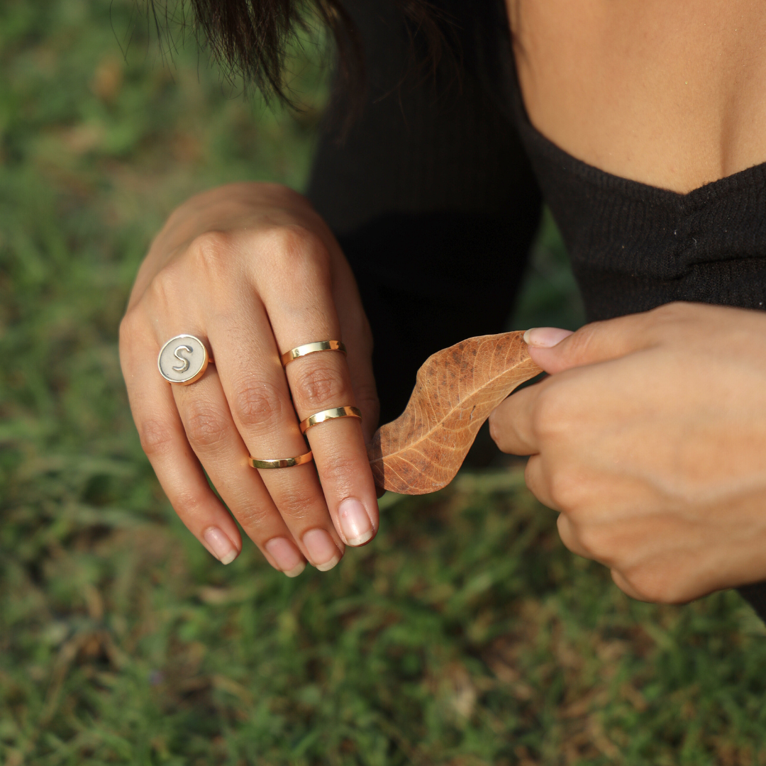 Handcrafted personalized alphabet ring made with cement and brass, finished in 18K rhodium gold