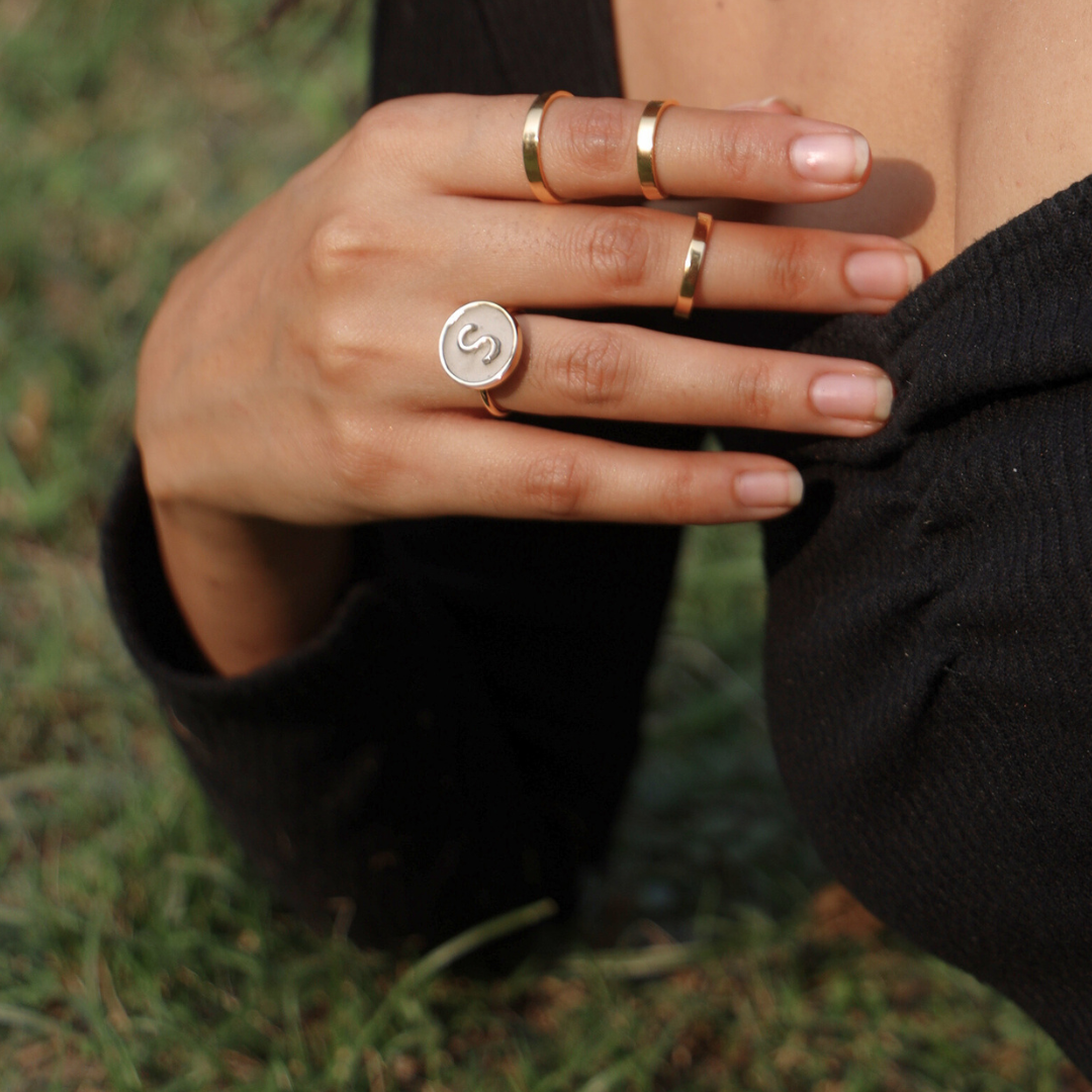 Handcrafted personalized alphabet ring made with cement and brass, finished in 18K rhodium gold