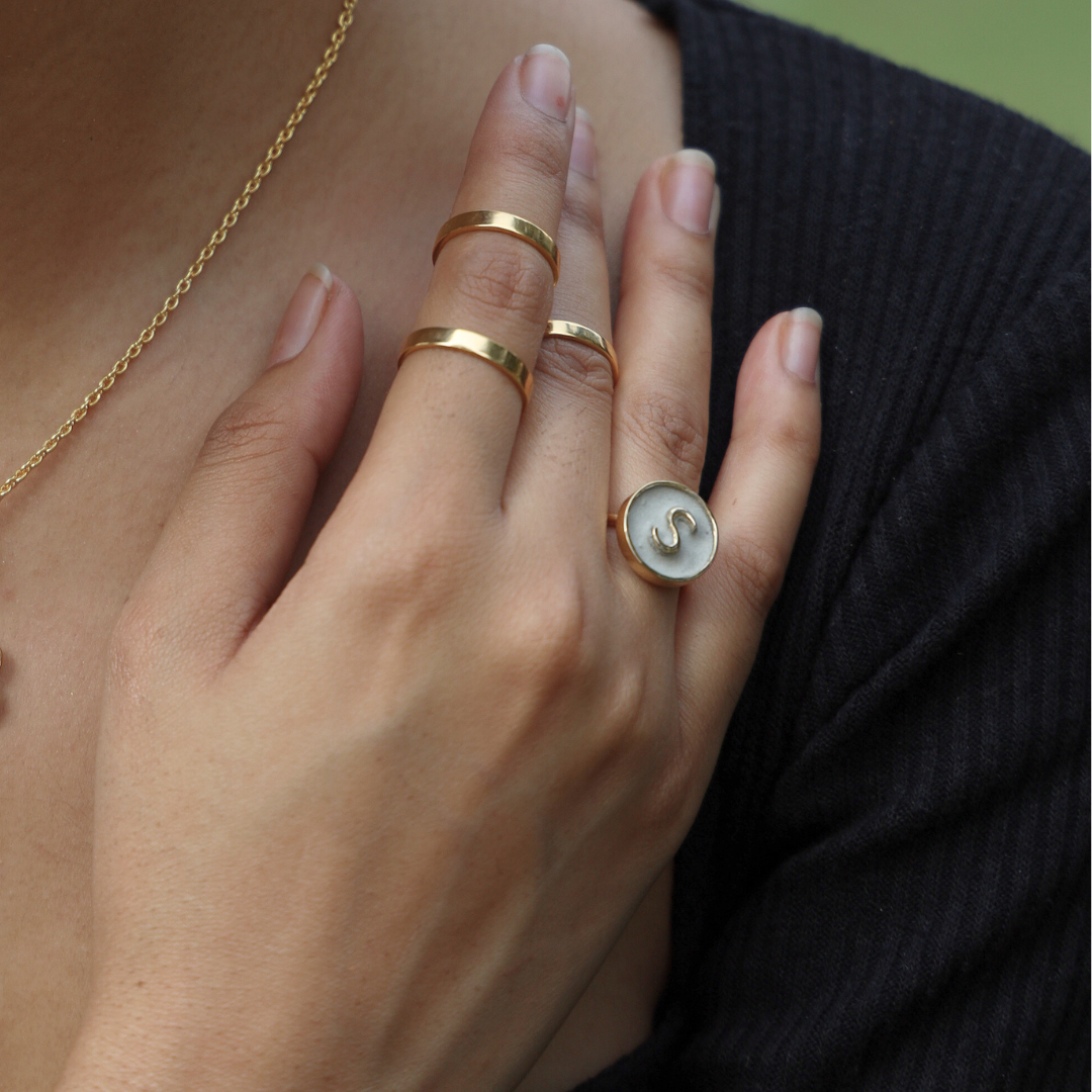 Handcrafted personalized alphabet ring made with cement and brass, finished in 18K rhodium gold
