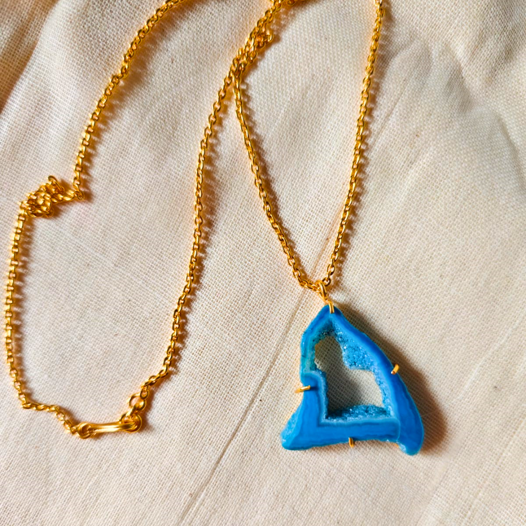 Blue druzy agate pendant with natural geode center on gold-toned brass chain