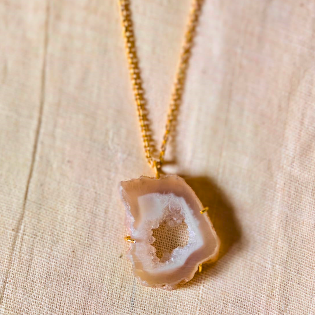 White druzy agate pendant with natural geode center on gold-toned brass chain