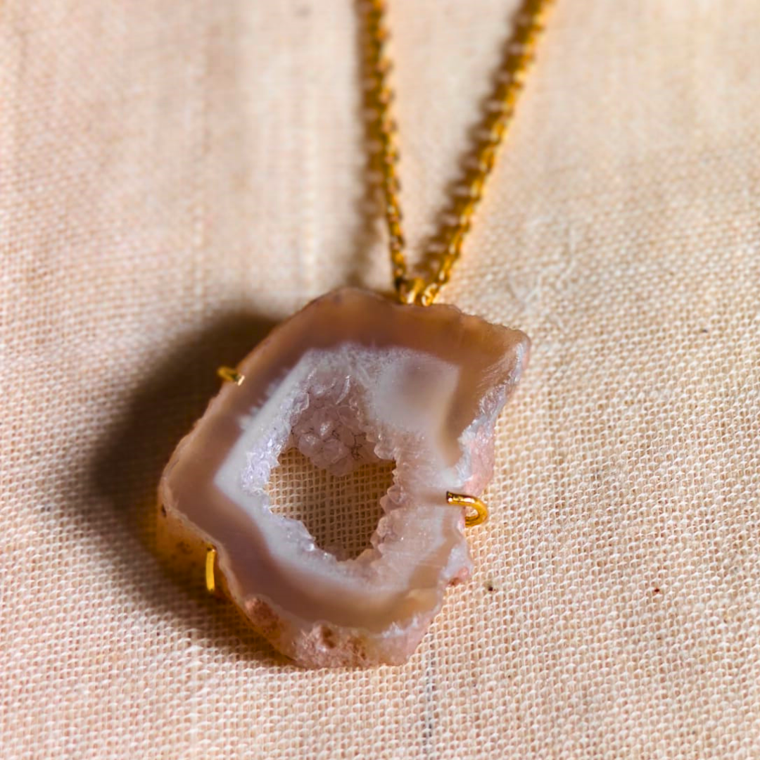 White druzy agate pendant with natural geode center on gold-toned brass chain