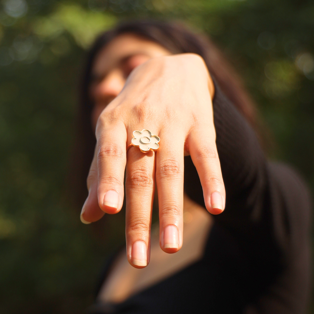 flower shaped ring on a models finger