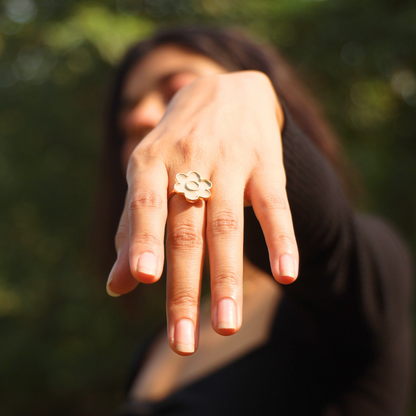 flower shaped ring on a models finger