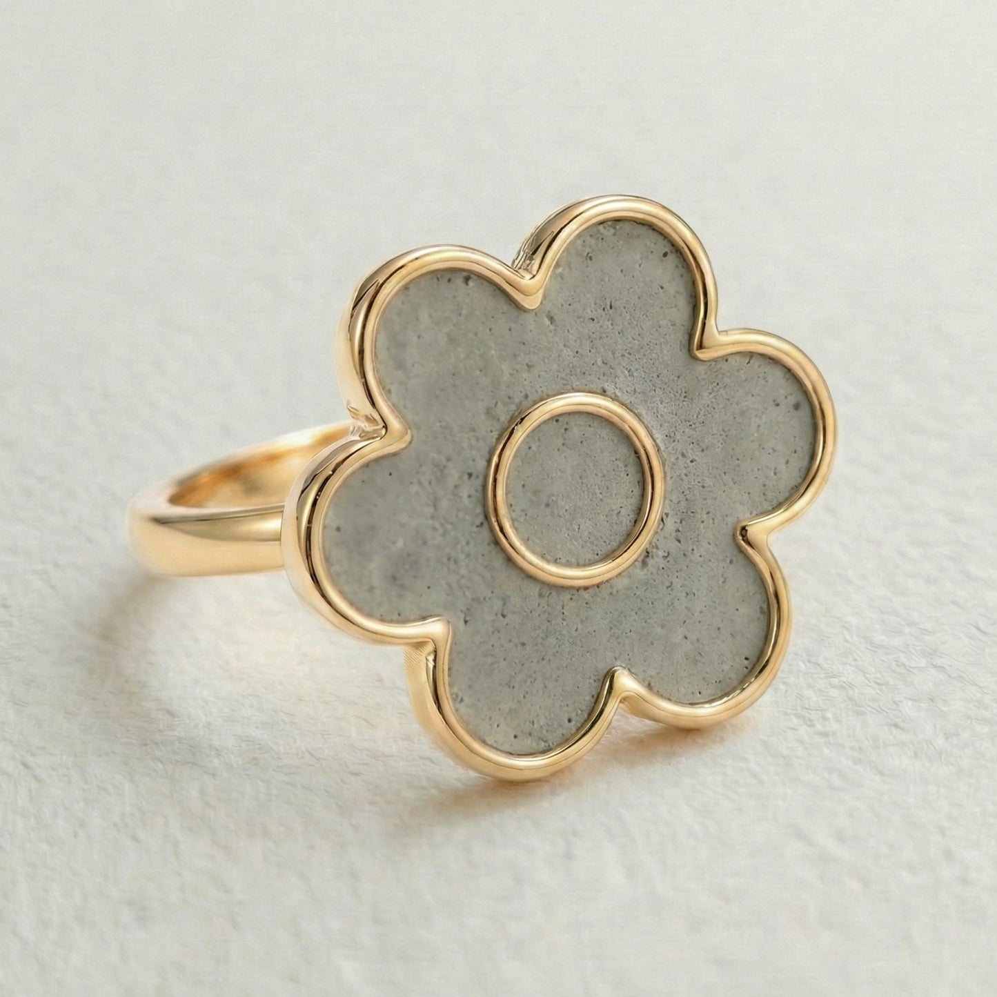 cement filled flower-shaped ring with gold outline