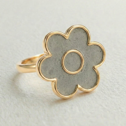 cement filled flower-shaped ring with gold outline