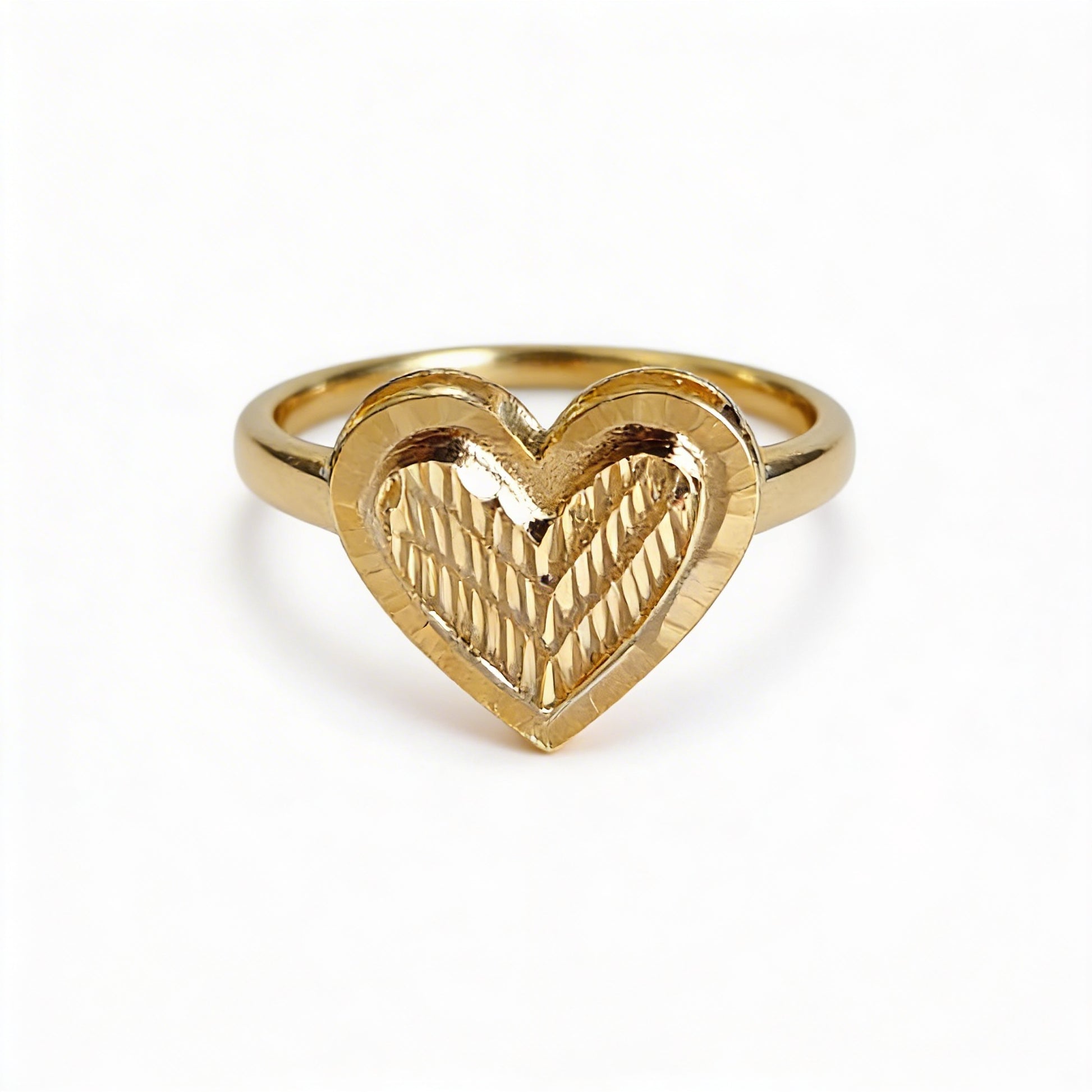 Gold heart-shaped ring on a white background