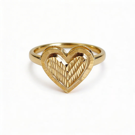 Gold heart-shaped ring on a white background