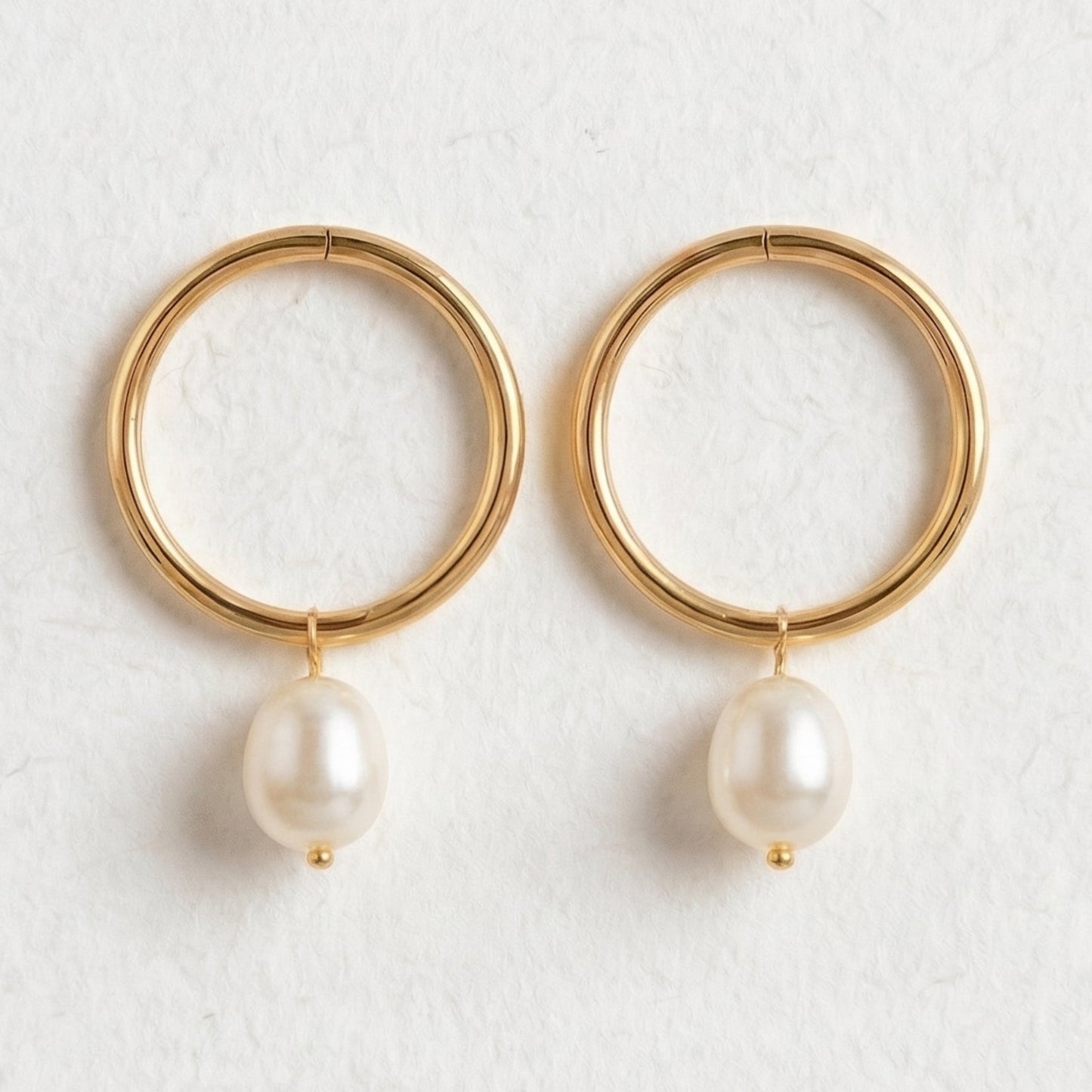 Gold hoop earrings with pearl drops