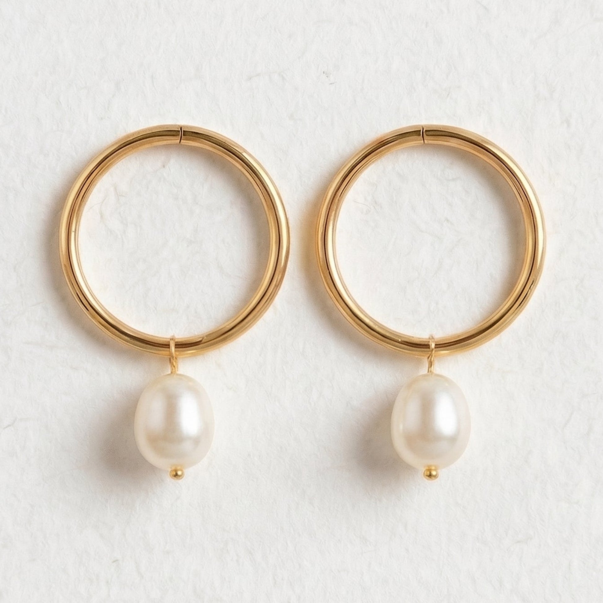 Gold hoop earrings with pearl drops