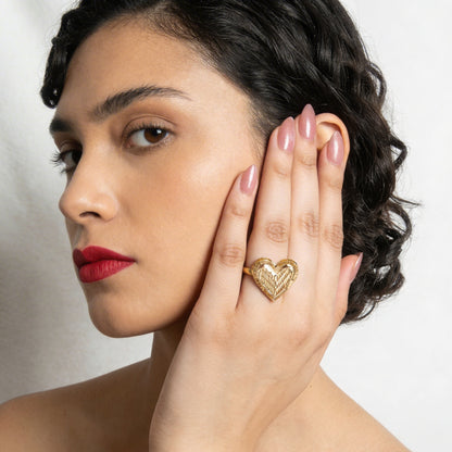 Woman wearing a gold ring with a heart design