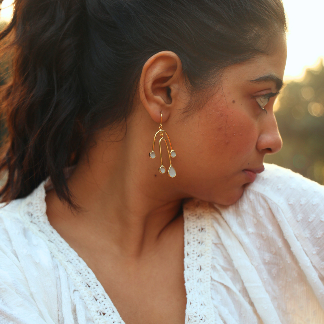 Model wearing playful cement earring design