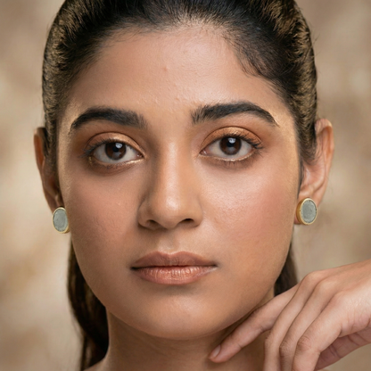 woman wearing cement gold earrings