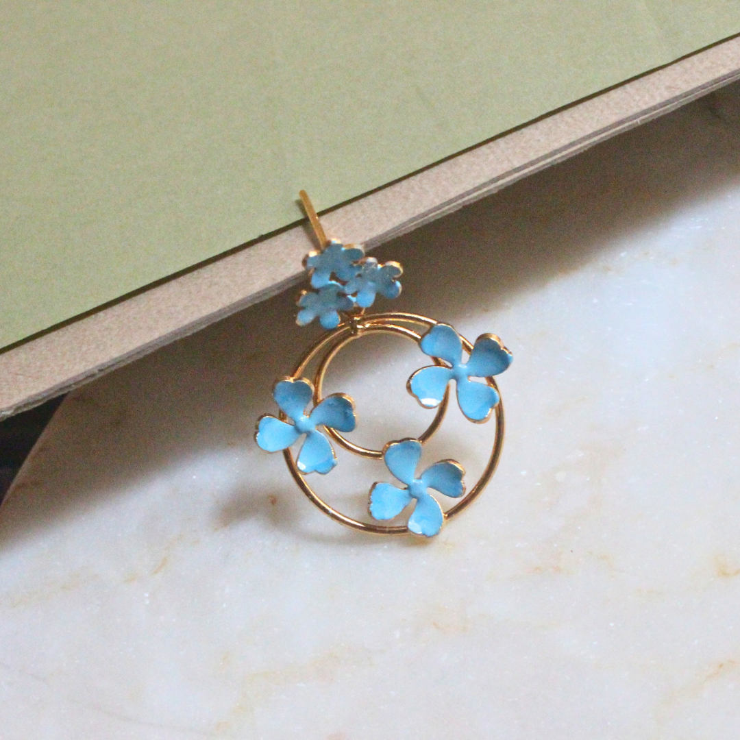 Blue Enamel Dangler Earrings featuring concentric gold-plated brass hoops adorned with delicate sky-blue enamel flowers