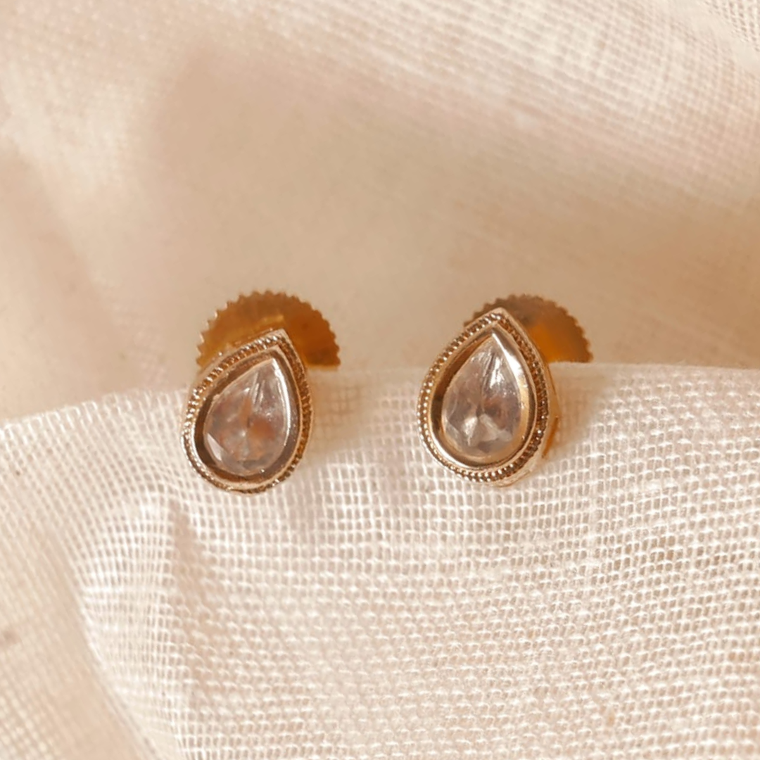 Handmade brass drop-shaped Kundan studs with gold rhodium finish and Kundan stone