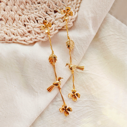 Gold Plated Long Dangler Earrings Featuring Delicate Twisted Stems, Floral Motifs, Textured Leaves, and Small Perched Birds