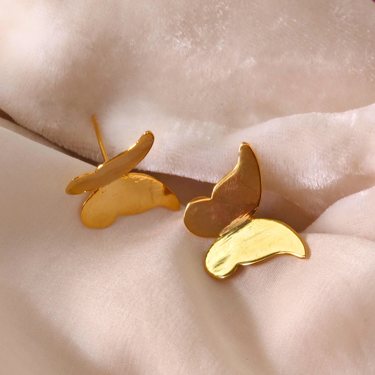 A pair of Gold Plated Butterfly Earrings featuring sleek, minimalist butterfly-shaped designs crafted from brass with a shiny 18k rhodium gold finish.