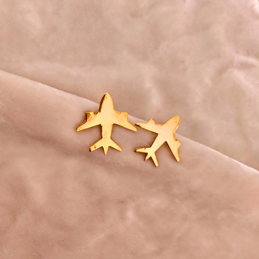 A pair of Gold Plated Aeroplane Earrings featuring minimalist airplane silhouettes crafted from brass and finished with a shiny 18k rhodium gold plating.








