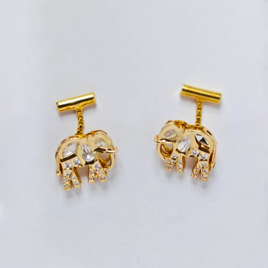 A pair of gold drop earrings shaped like elephants, embellished with sparkling Kundan stones on their bodies and legs, suspended from short vertical bars