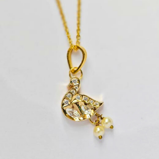 Gold swan-shaped pendant adorned with Kundan stones and two hanging pearl drops