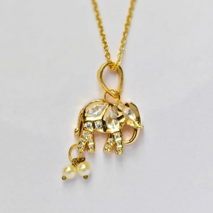 Gold elephant-shaped pendant embellished with Kundan stones and two hanging pearl drops