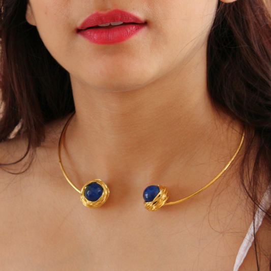 Handcrafted Torc-style necklace featuring two faceted blue onyx stones wrapped in golden wire on an open choker brass band with 18K rhodium gold plating