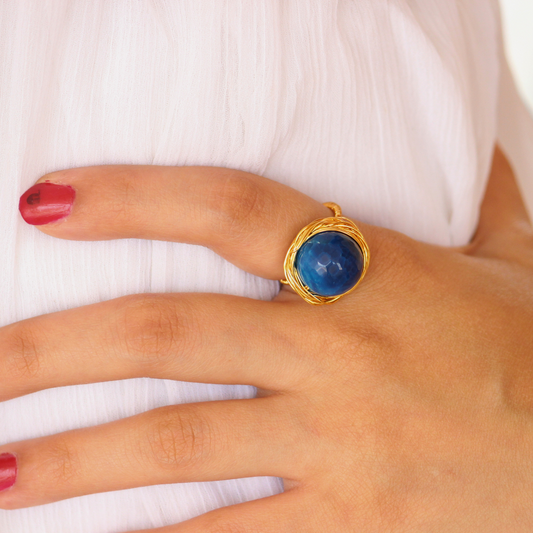 Handcrafted Blue Onyx Ring featuring a deep oceanic faceted gemstone set in a twisted brass band with 18K rhodium gold plating