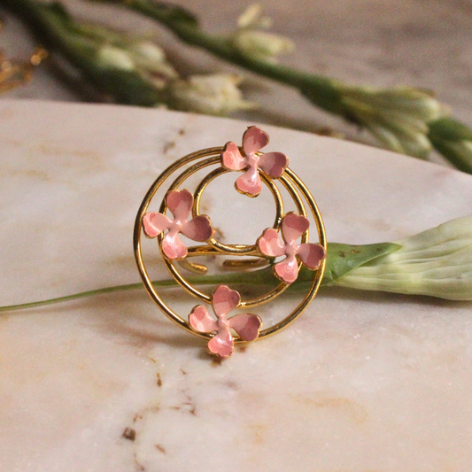 Pink Enamel Blossom Orbit Ring featuring concentric gold-plated brass circles adorned with delicate pink enamel flowers