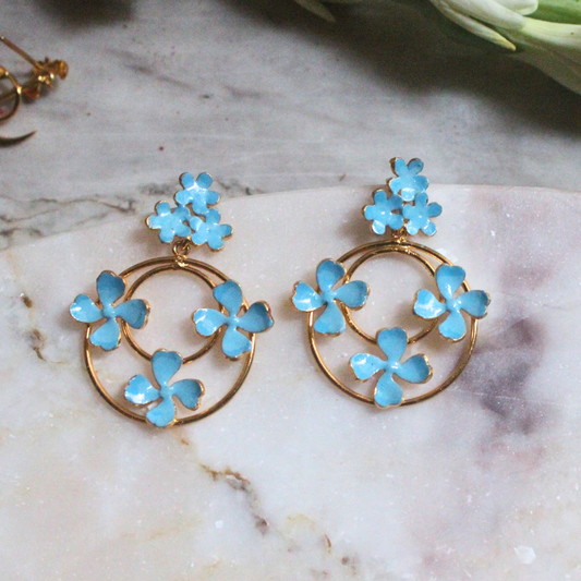 Blue Enamel Dangler Earrings featuring concentric gold-plated brass hoops adorned with delicate sky-blue enamel flowers