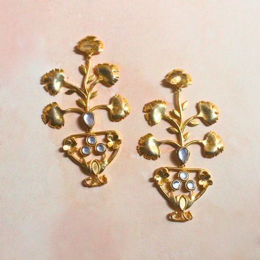 Pair of brass and 18k rhodium gold plated statement earrings with sculptural floral designs emerging from ornate urn-shaped bases, accented with luminous stones