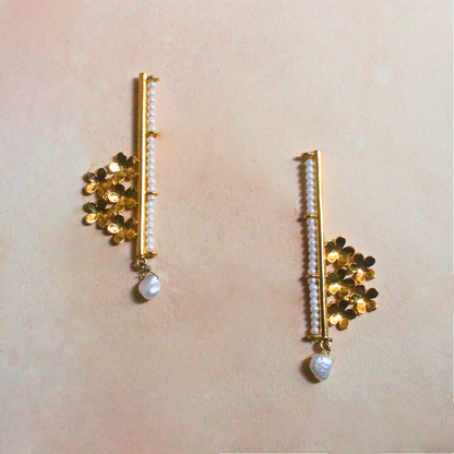Handcrafted brass earrings with 18K rhodium gold plating, featuring golden floral clusters, a vertical row of faux pearl beads, and a single drop pearl