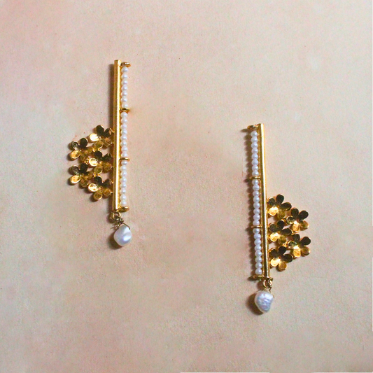 Handcrafted brass earrings with 18K rhodium gold plating, featuring golden floral clusters, a vertical row of faux pearl beads, and a single drop pearl