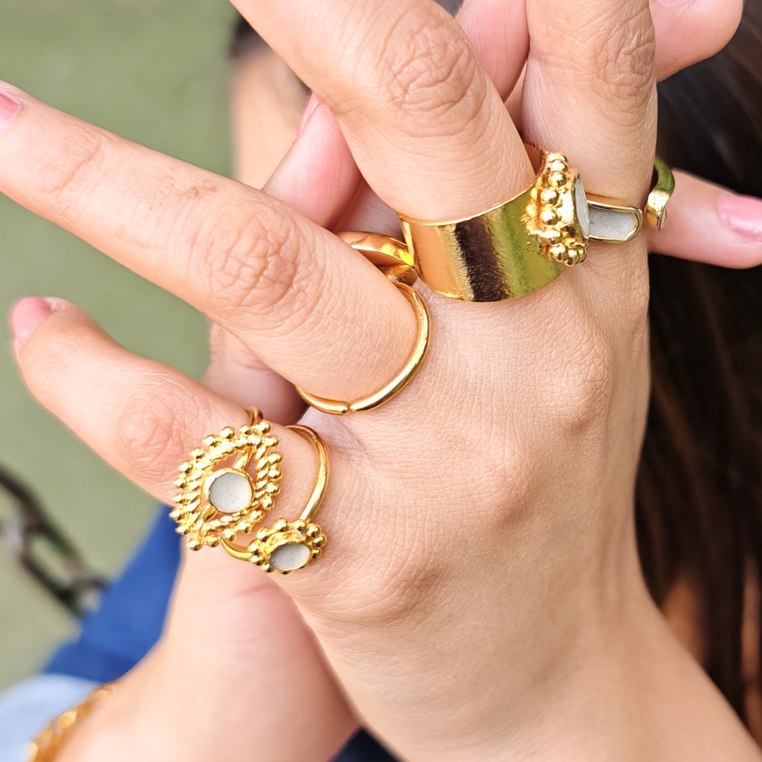 Gold-plated Cement Ember Ring with a smooth cement center and intricate beaded halo design