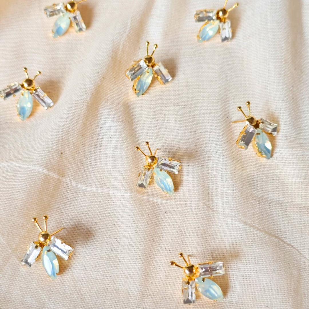 White and opal gold bug ear studs with brass, faux opal navette center and 18K rhodium gold finish