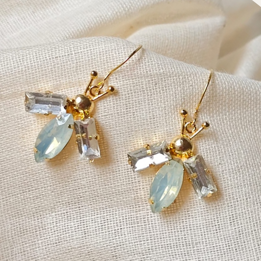 Lightweight bug-inspired earrings with brass, faux opal accents and 18K rhodium gold-plated 