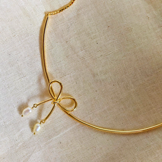 18K rhodium gold-plated brass bow necklace with baroque pearl drops