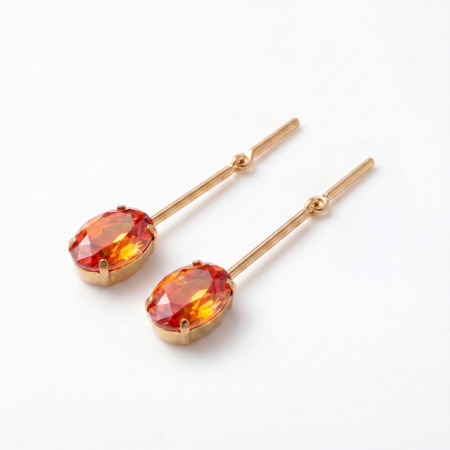 Side view of orange CZ gold bar drop earrings showing decorative knot detail and claw setting – KANSYA