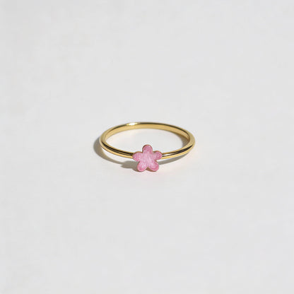 Gold ring with a pink enamel detailing on flower shape