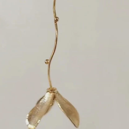 Hanging flower earrings with matte-gold petals and flowing vine stems, made from brass and 18K rhodium gold plating