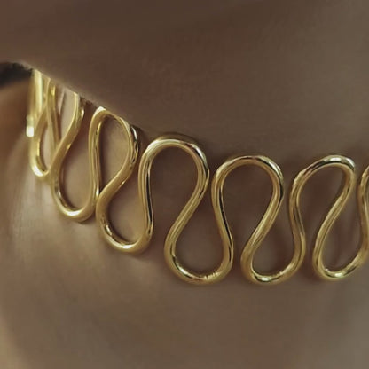 Gold-plated Spiral Cuff Necklace crafted from brass, featuring a continuous wave-like design