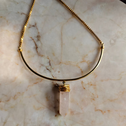 Necklace with a pendant on a marble surface
