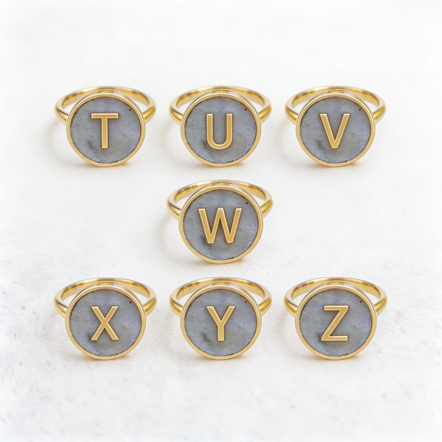 Set of gold letter rings with cement