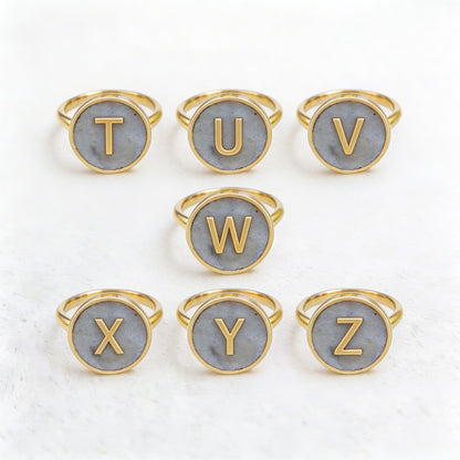 Set of gold letter rings with cement